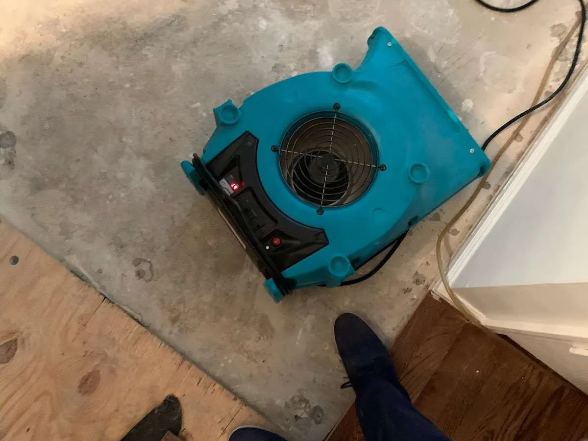 Air mover drying subfloor during Leak Detection & Repair in Muskegon Heights